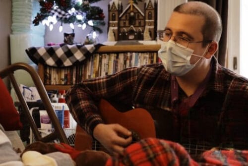 Resident enjoying music with staff member