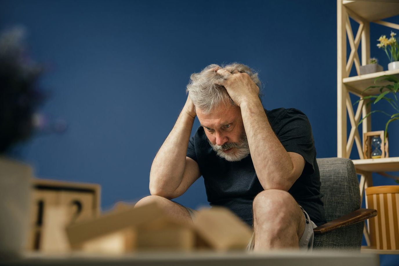 Assisting Hands Home Care Cincinnati, home care in Cincinnati, OH — Man holding his head in a contemplative pose