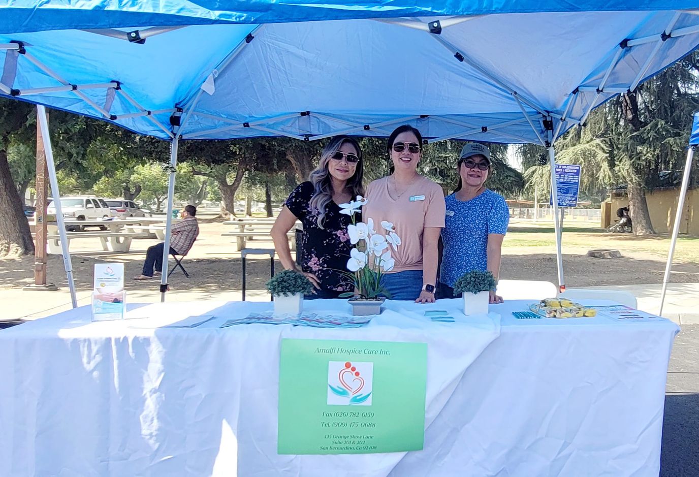 Staff members at a booth outside at an event