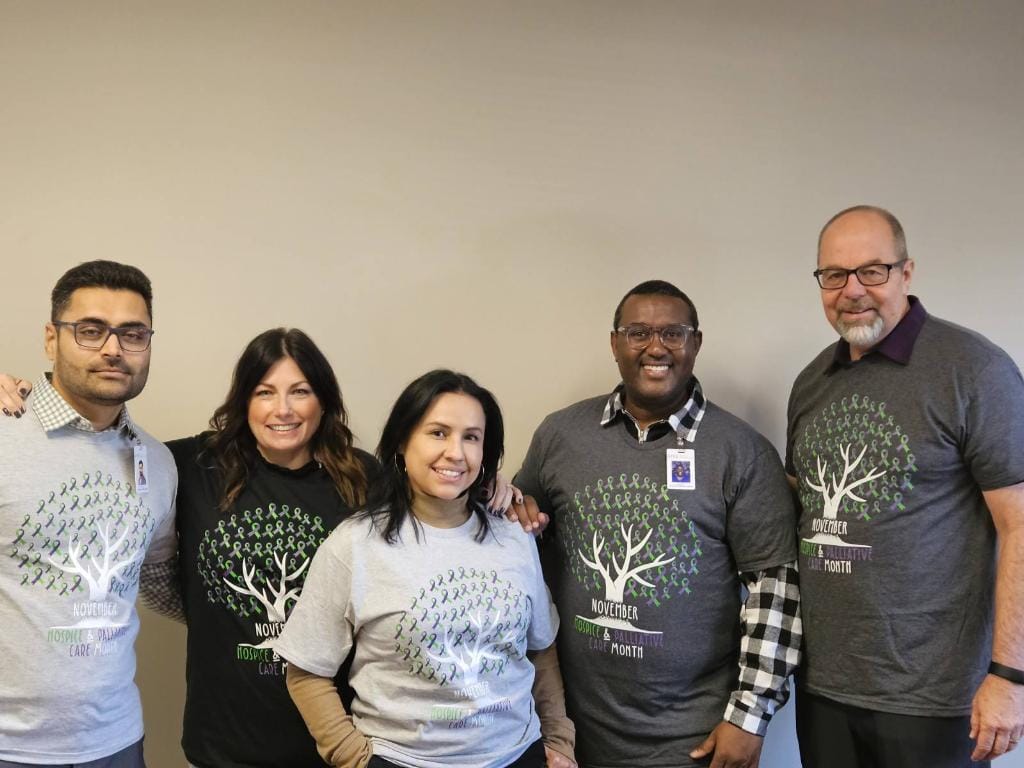 Staff members wearing promotional shirts in an interior space