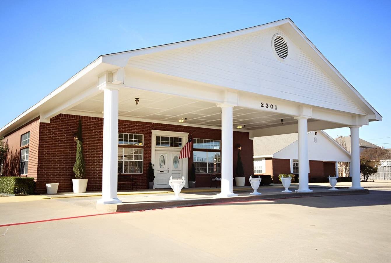 Exterior view of the facility entrance with white pillars