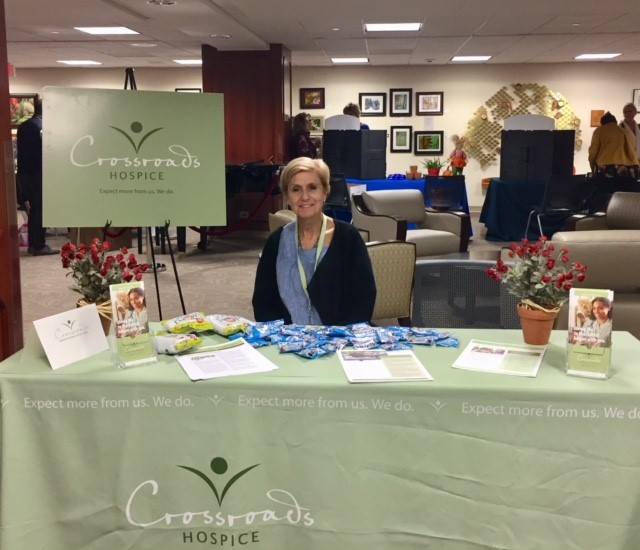 Staff member at a reception table in organized interior space