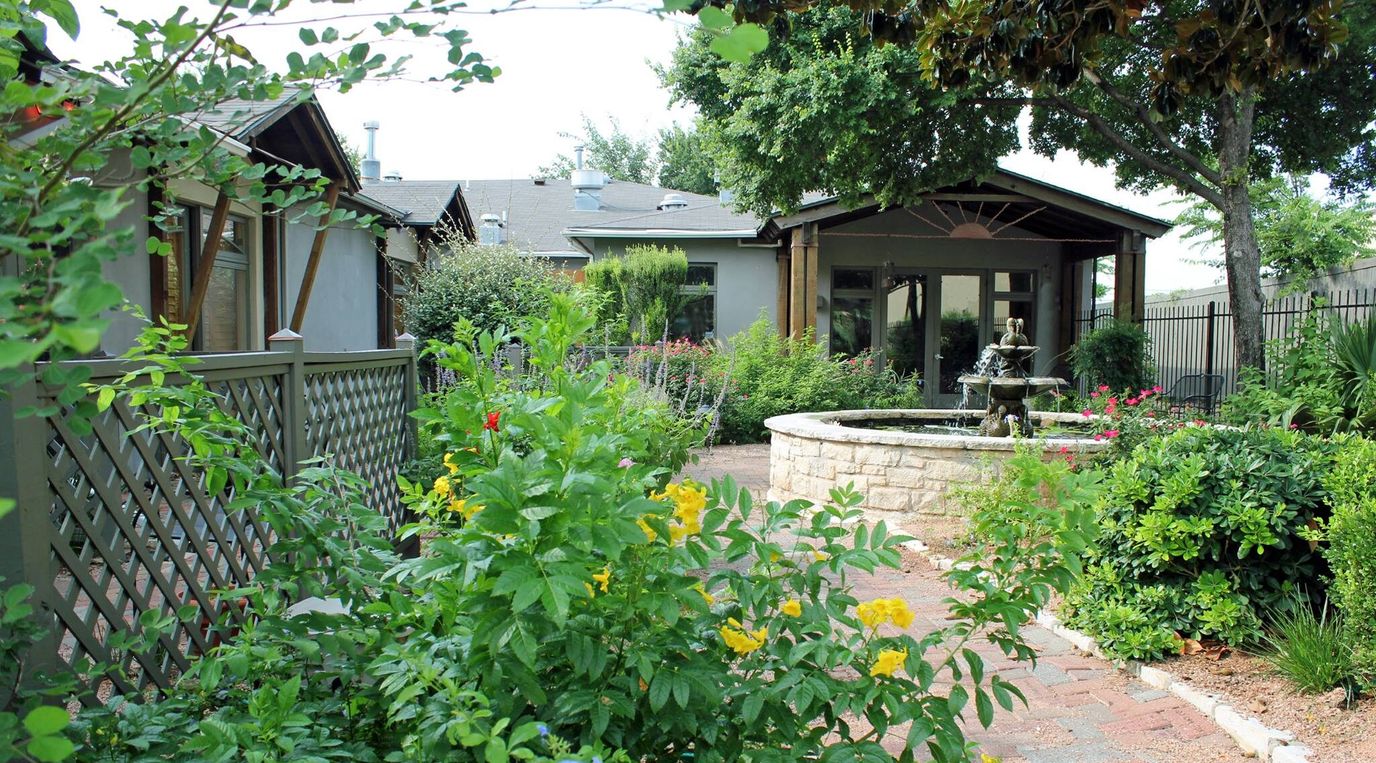 Serene courtyard with fountain and colorful flowers