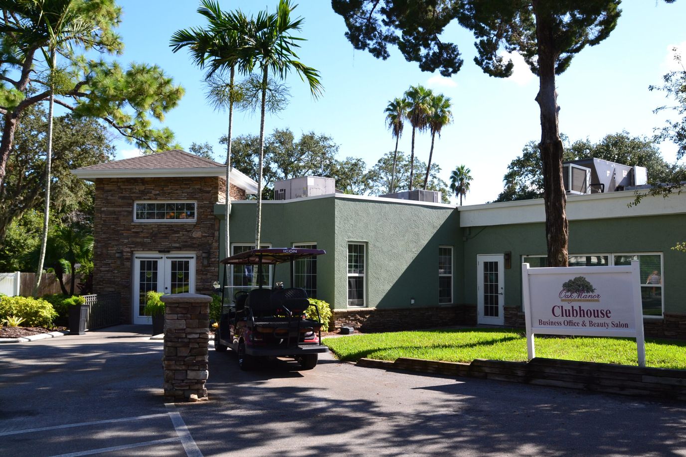Exterior view of the clubhouse with a vehicle parked outside