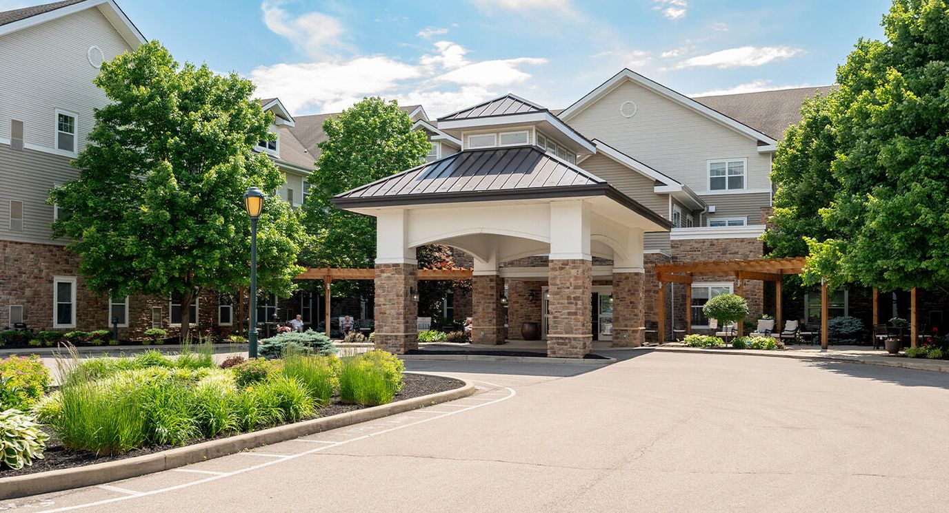 Exterior view of Pinebrook entrance with trees and landscaping