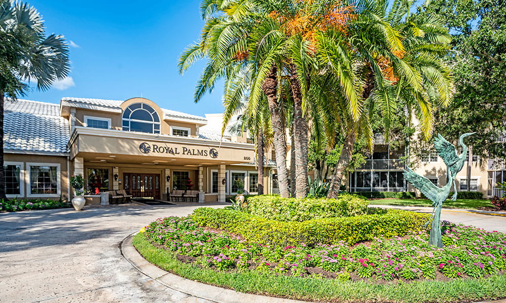 Exterior view of the Royal Palms entrance with landscaping