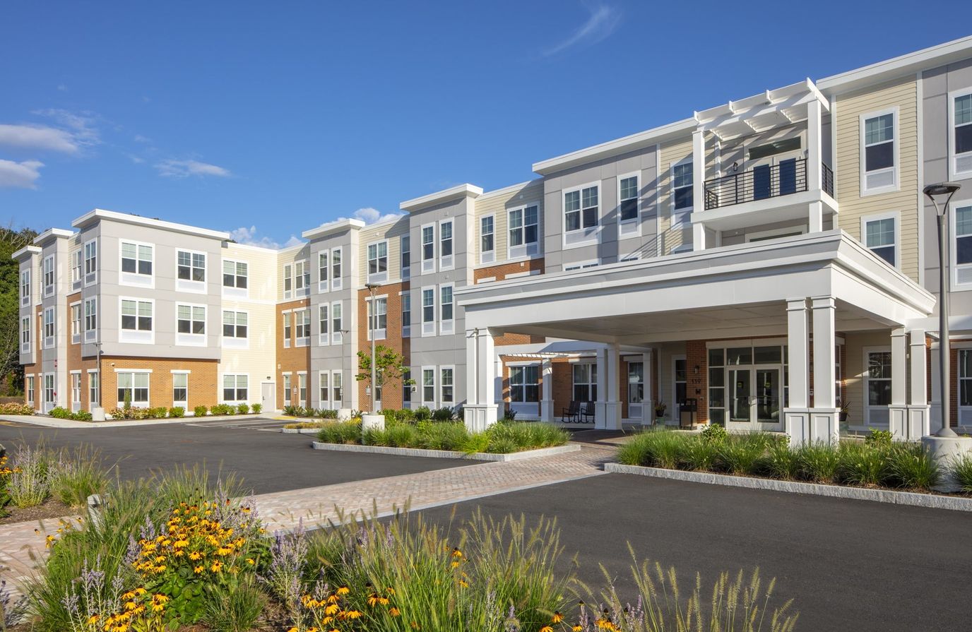 Exterior view of a senior living facility with landscaping
