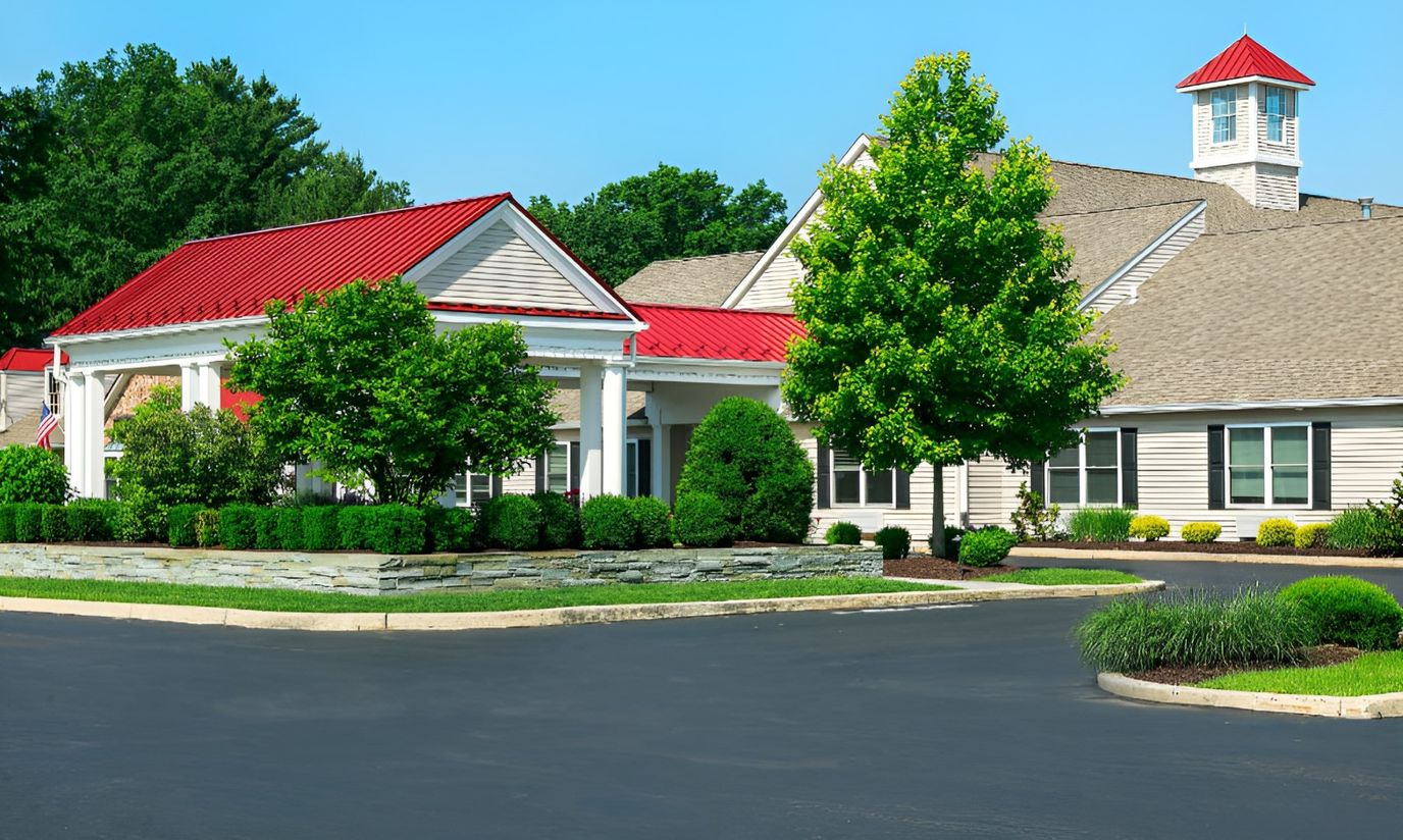 Exterior view of a senior living facility with landscaped entrance
