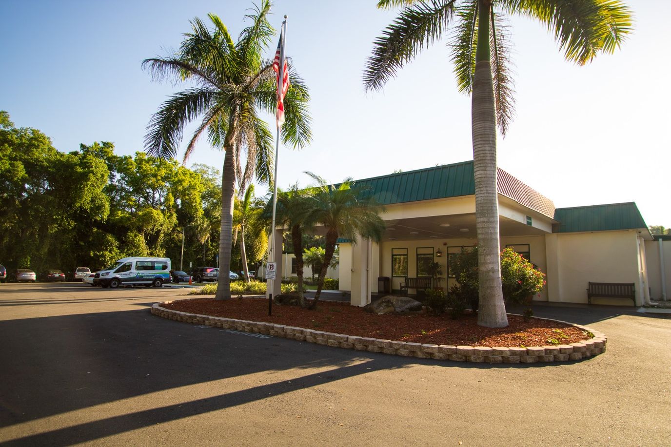 Exterior of Woodbridge Care Center with palm trees