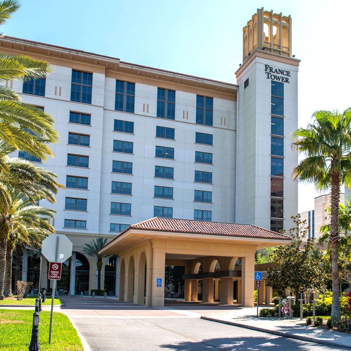 Exterior view of France Tower with palm trees