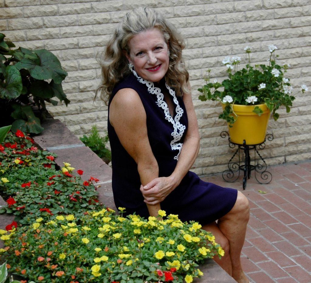 Elder Guidance, LLC, senior care in Longmont, CO — Woman sitting among colorful flowers in a garden