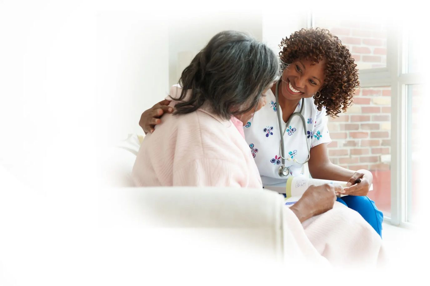 Caregiver interacting with a resident in a cozy setting