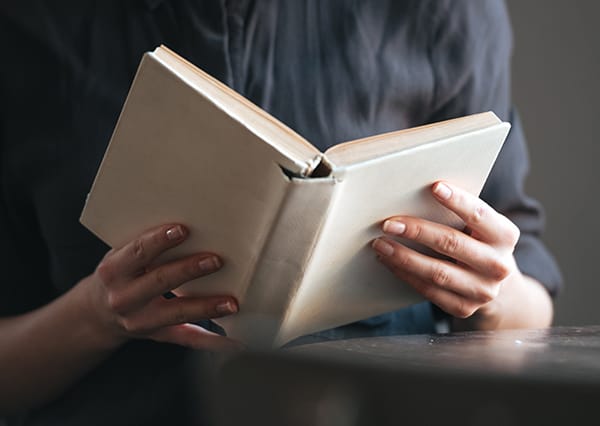 Person holding a closed book