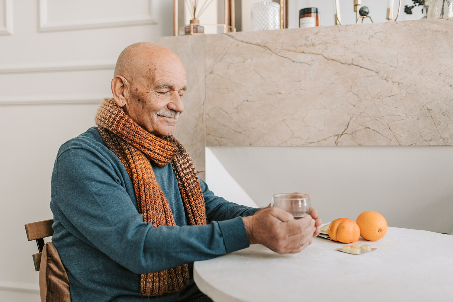 Senior man enjoying a drink with fruit