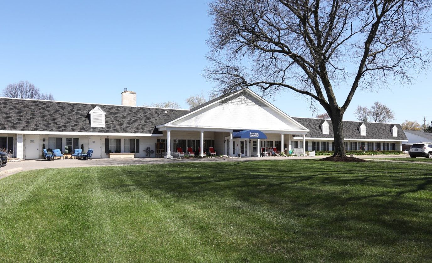 Exterior view of American House Dearborn Heights with lawn