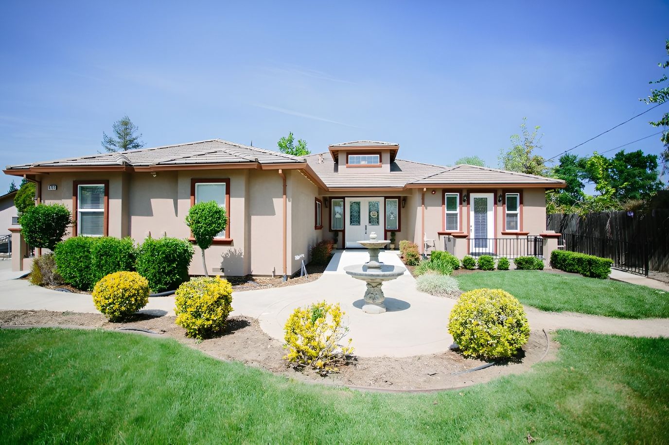 Exterior view of the assisted living facility with landscaped gardens