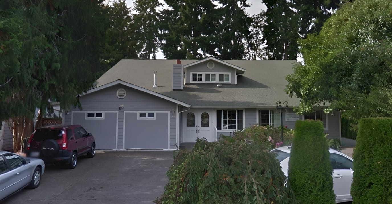 Exterior view of a senior living facility with landscaping