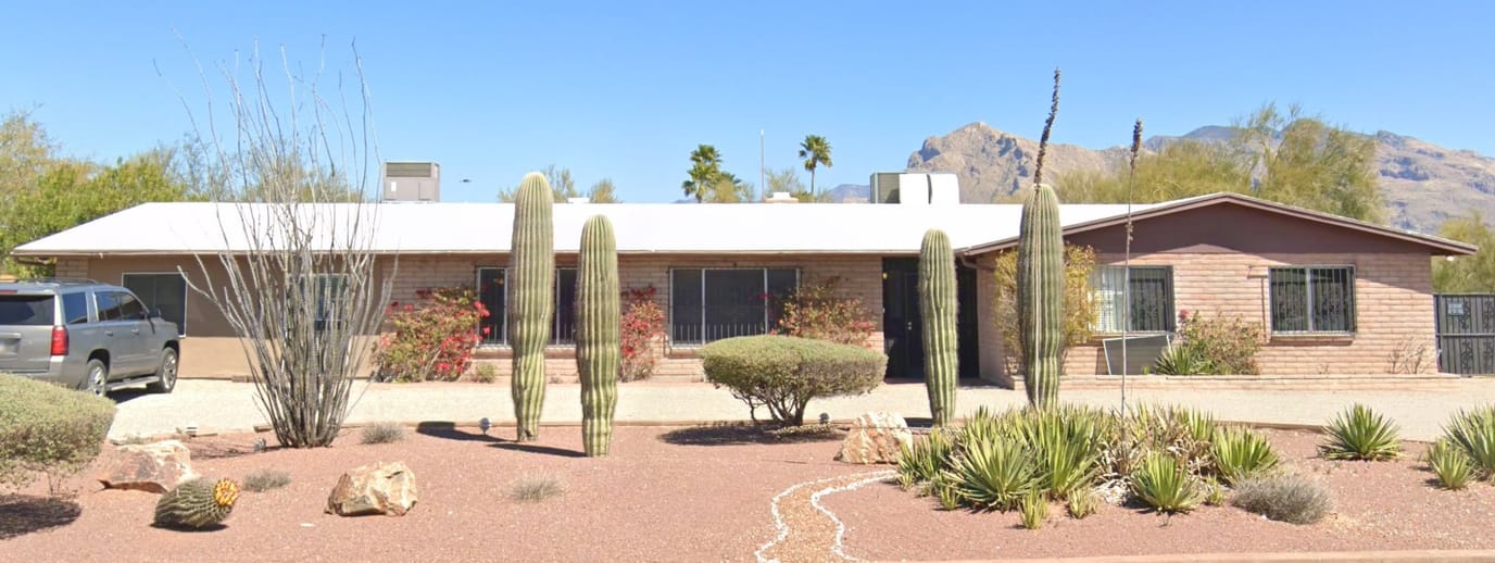 Exterior view of a senior living facility with desert landscaping