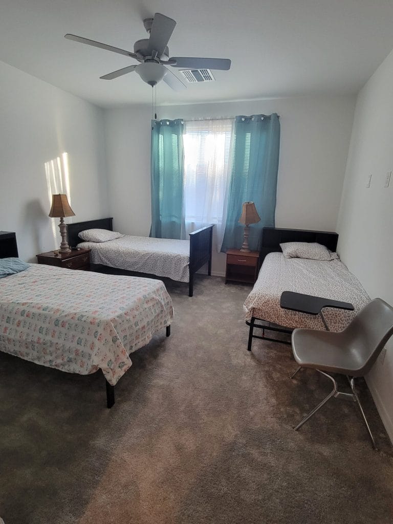 Shared resident room with two beds and light decor