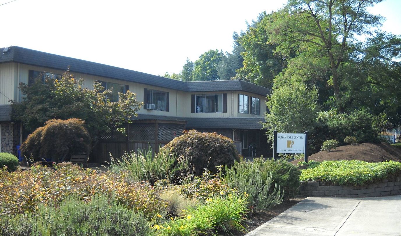 Exterior view of a senior care facility with landscaped garden