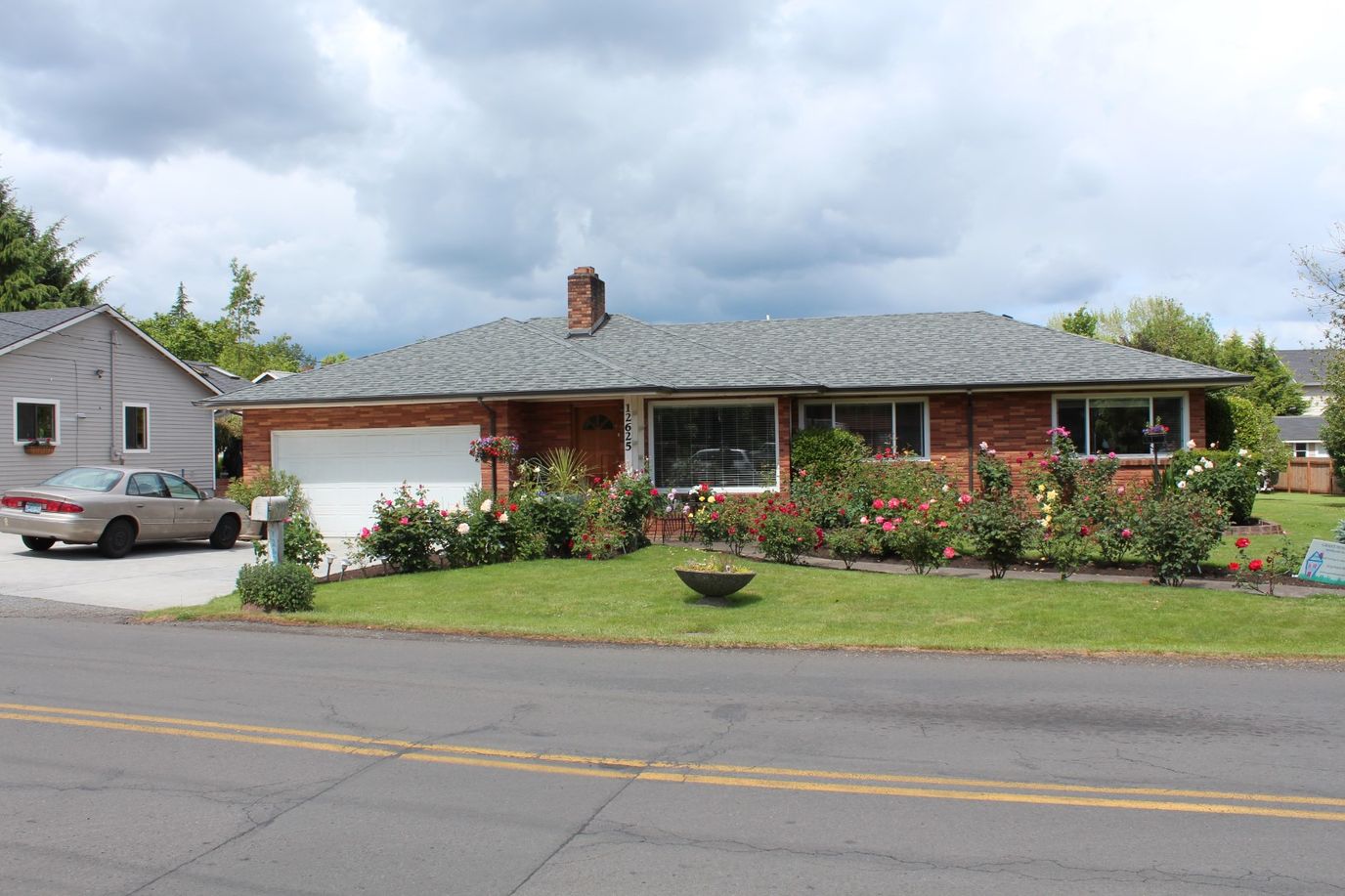 Exterior view of a single-story house with garden