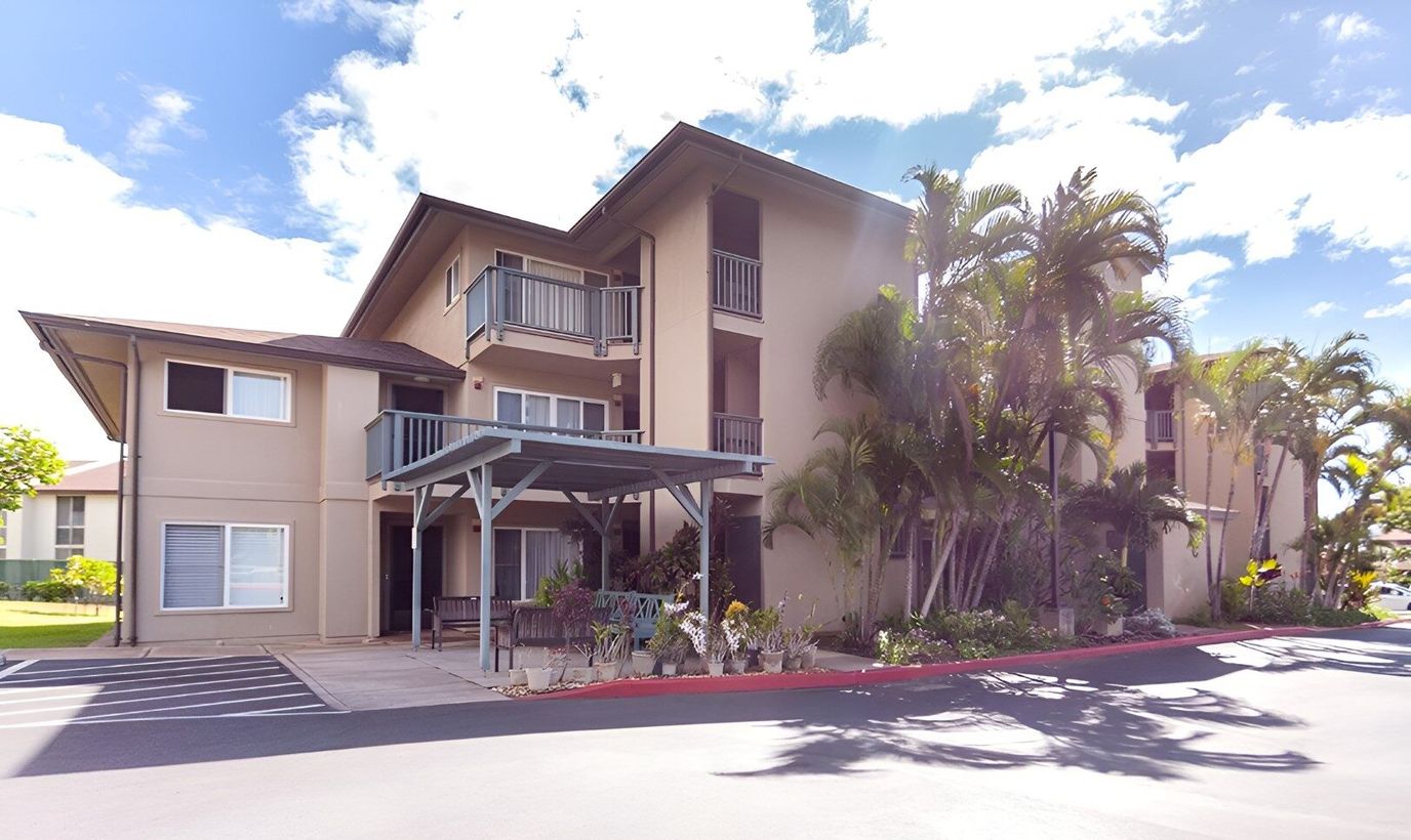 Exterior view of a senior living facility with landscaping