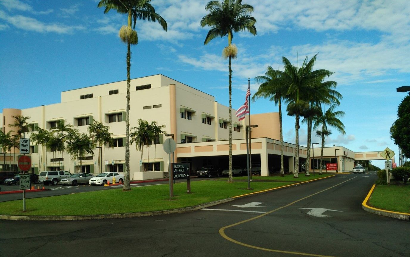 Exterior view of Hilo Medical Center with palm trees