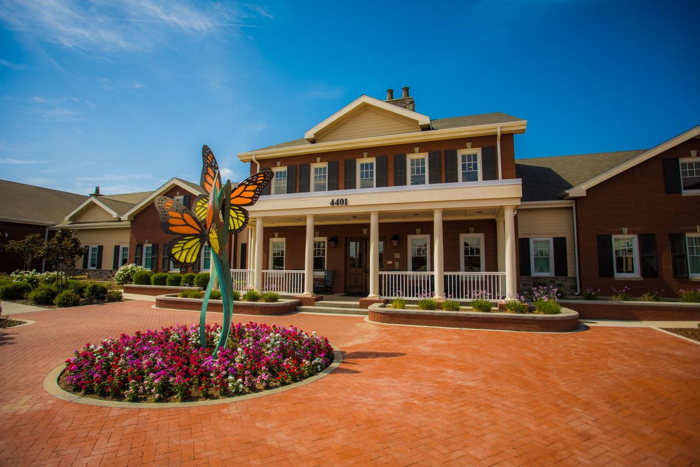Exterior view of a senior care facility with colorful flowers
