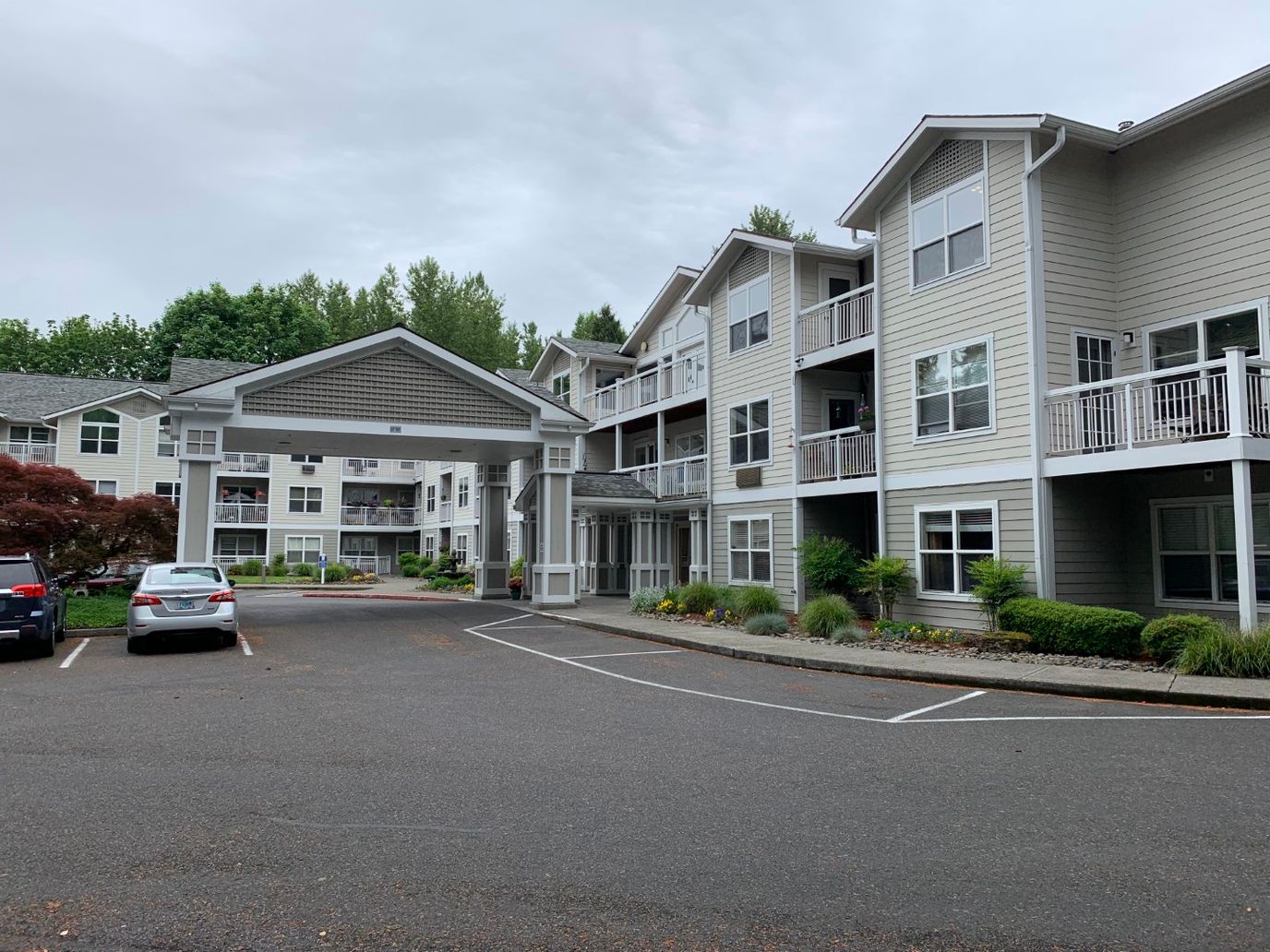 View of building exterior with entrance and parking area
