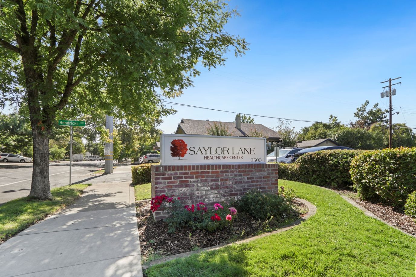 Exterior sign of Saylor Lane Health Care Center with landscaping