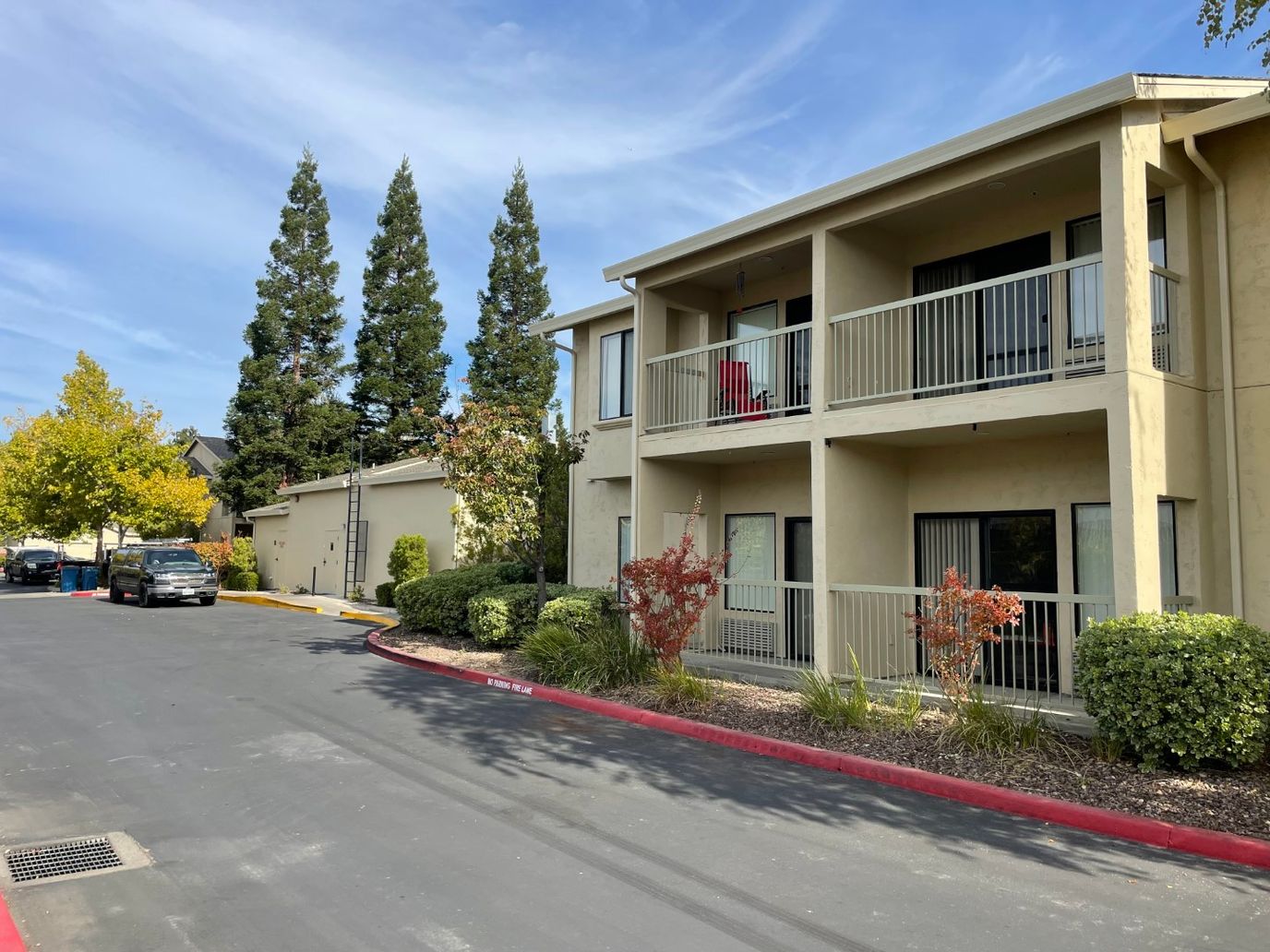 Building exterior with balconies and landscaped area