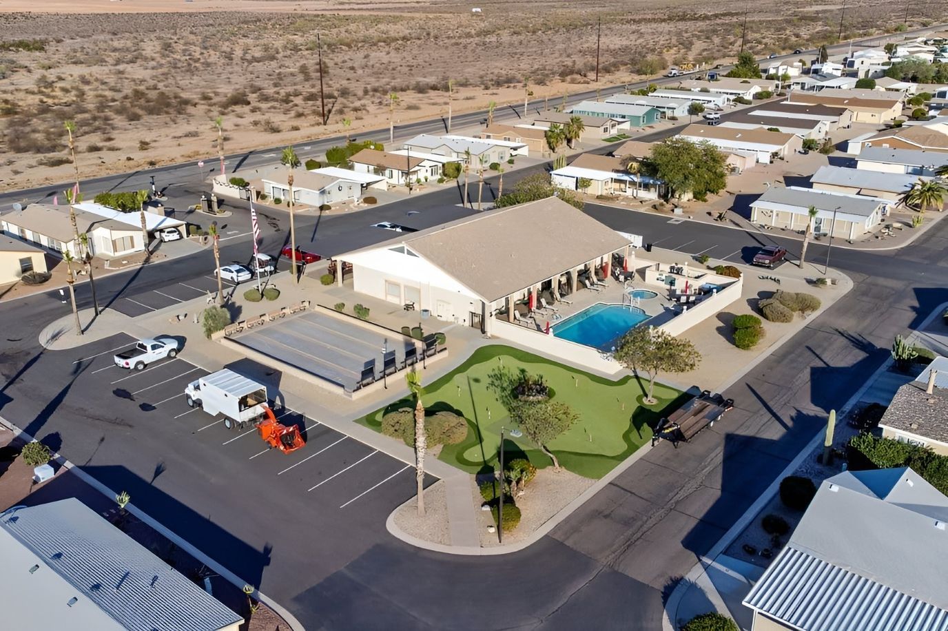 Aerial view of a senior community facility with pool and green space