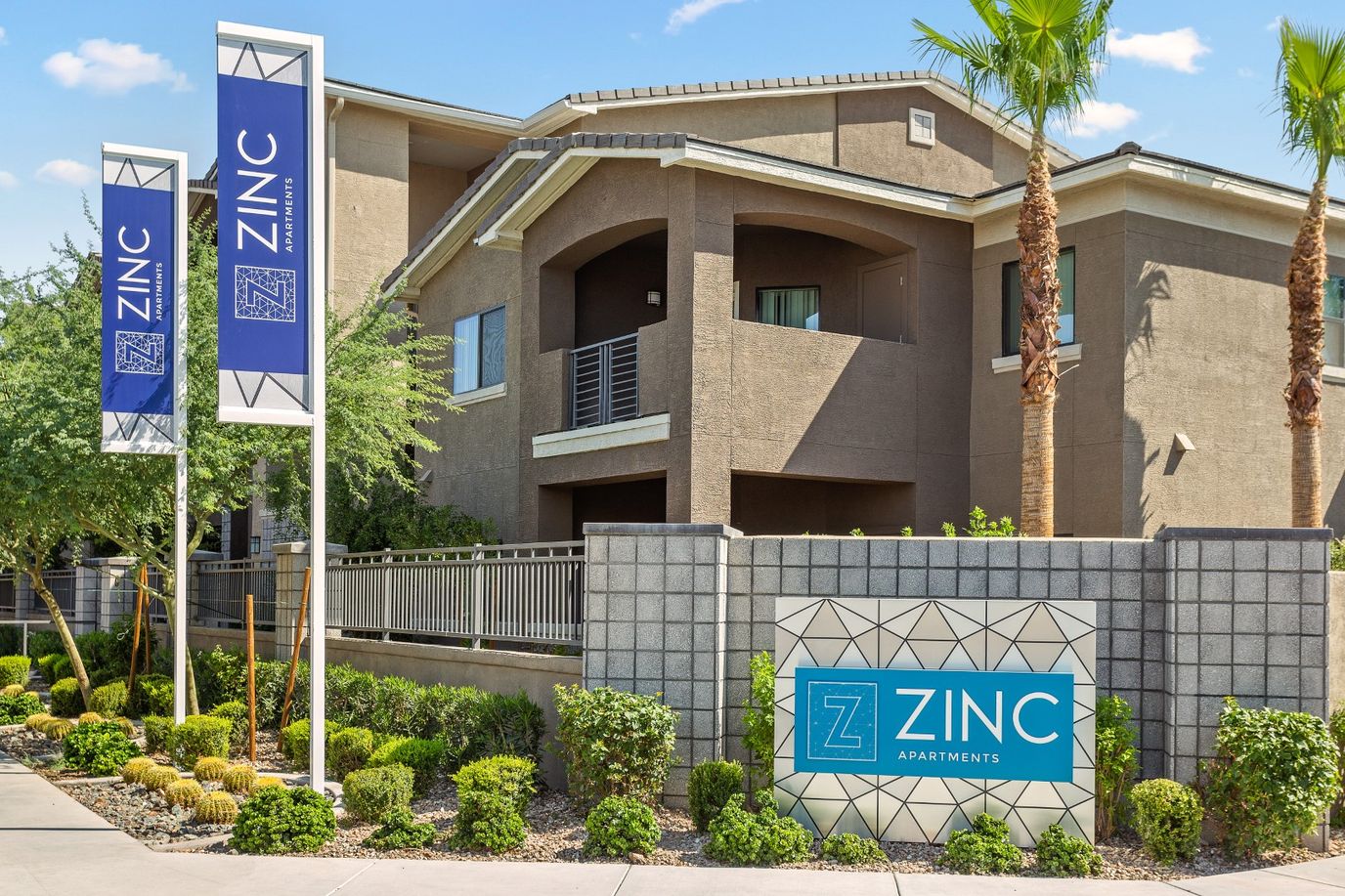 Exterior view of Zinc Apartments building with logo signage
