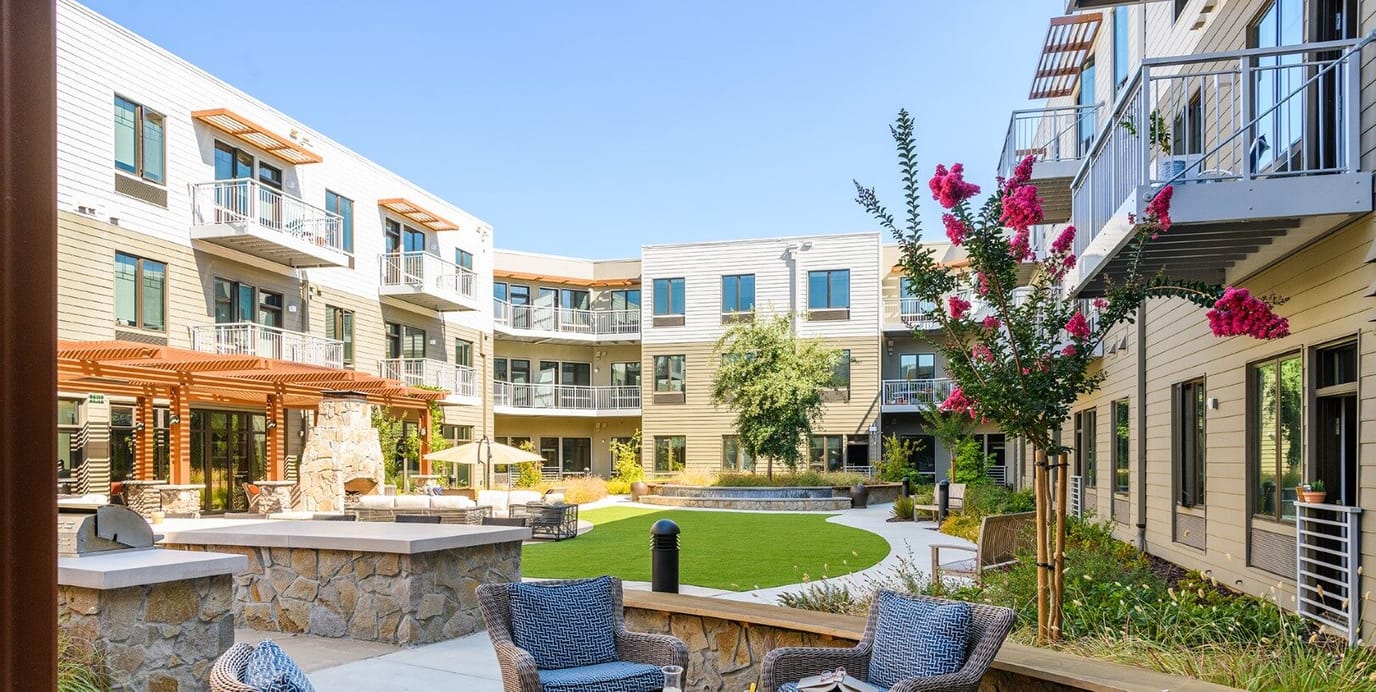 Outdoor courtyard with building facades and seating areas