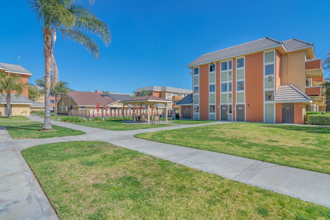 Exterior view of The Orchards Apartments with landscaping