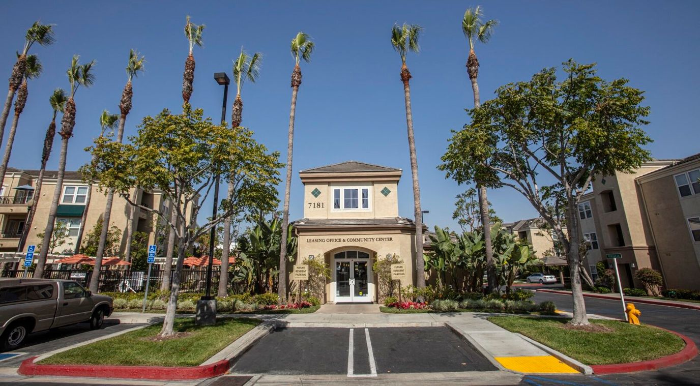 Exterior view of FountainGlen Seacliff building with palm trees
