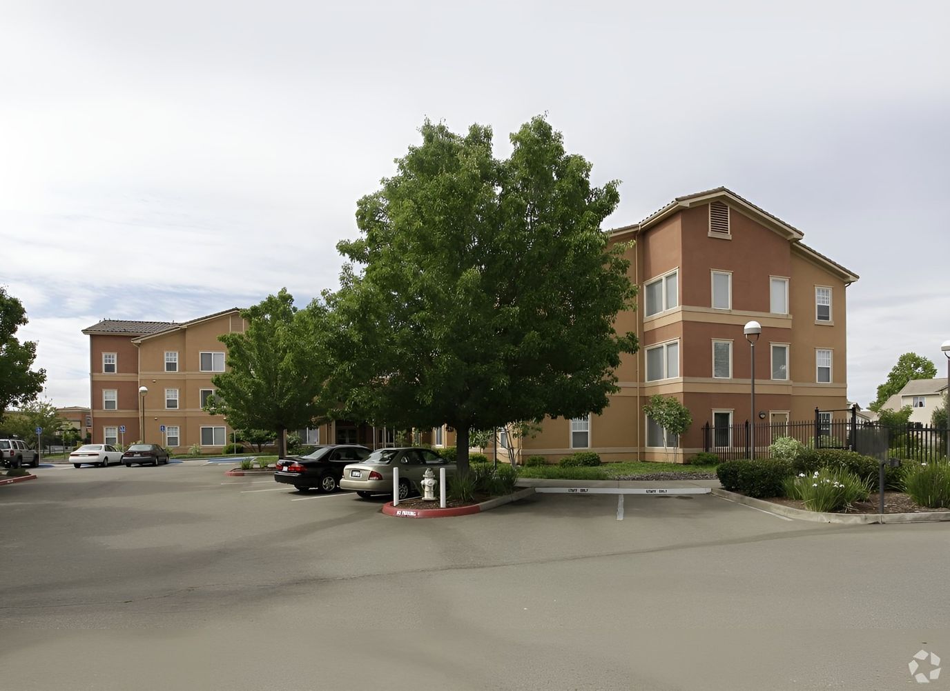 Exterior view of a senior living facility with parking
