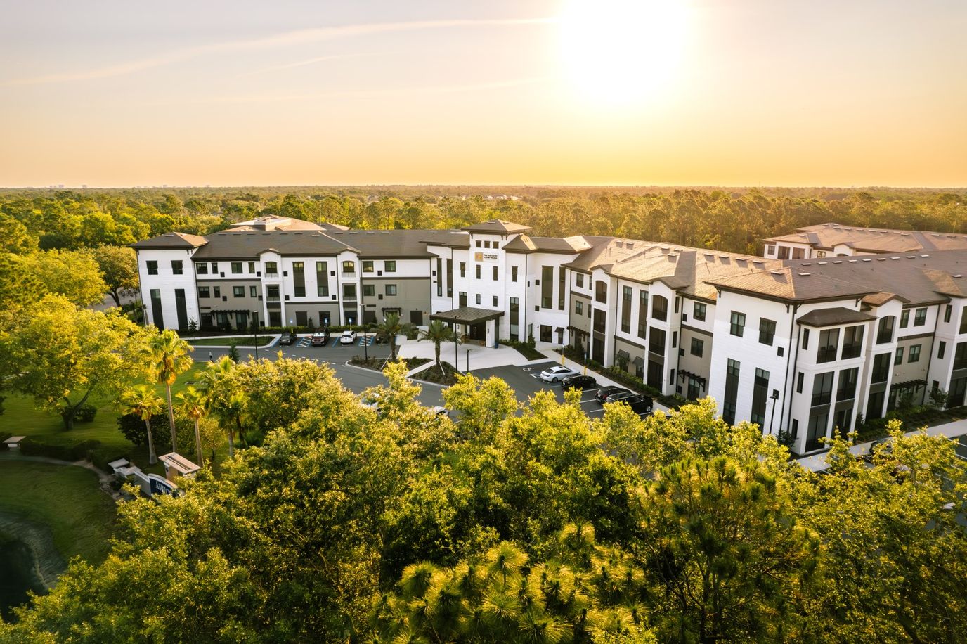 Aerial view of a senior living facility surrounded by trees