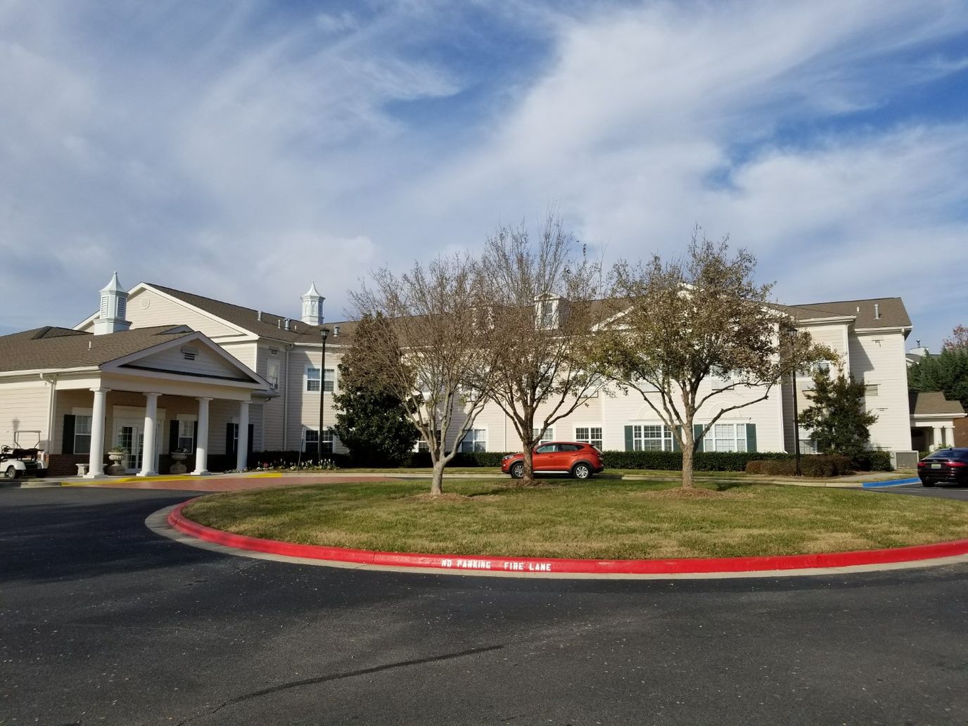 Exterior view of Magnolia Trace with trees and parking lot