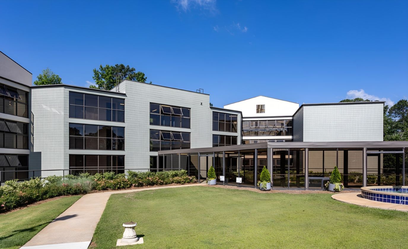 Exterior view of Arbor Lake's facility with green space