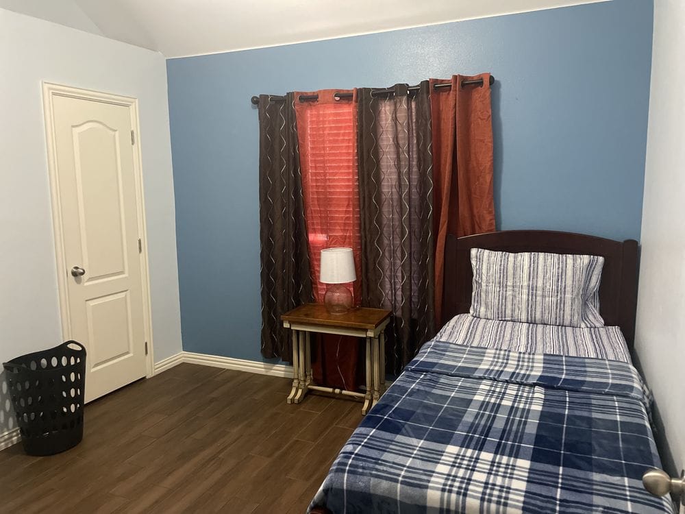 Private bedroom with a bed and lamp