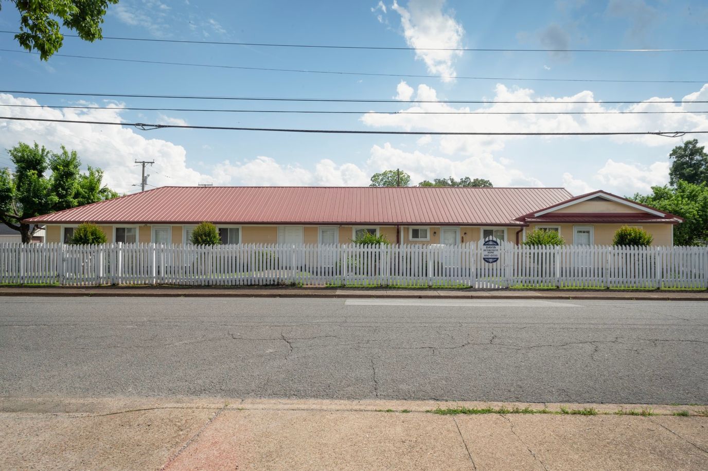Exterior view of Davis Retirement Home with white picket fence