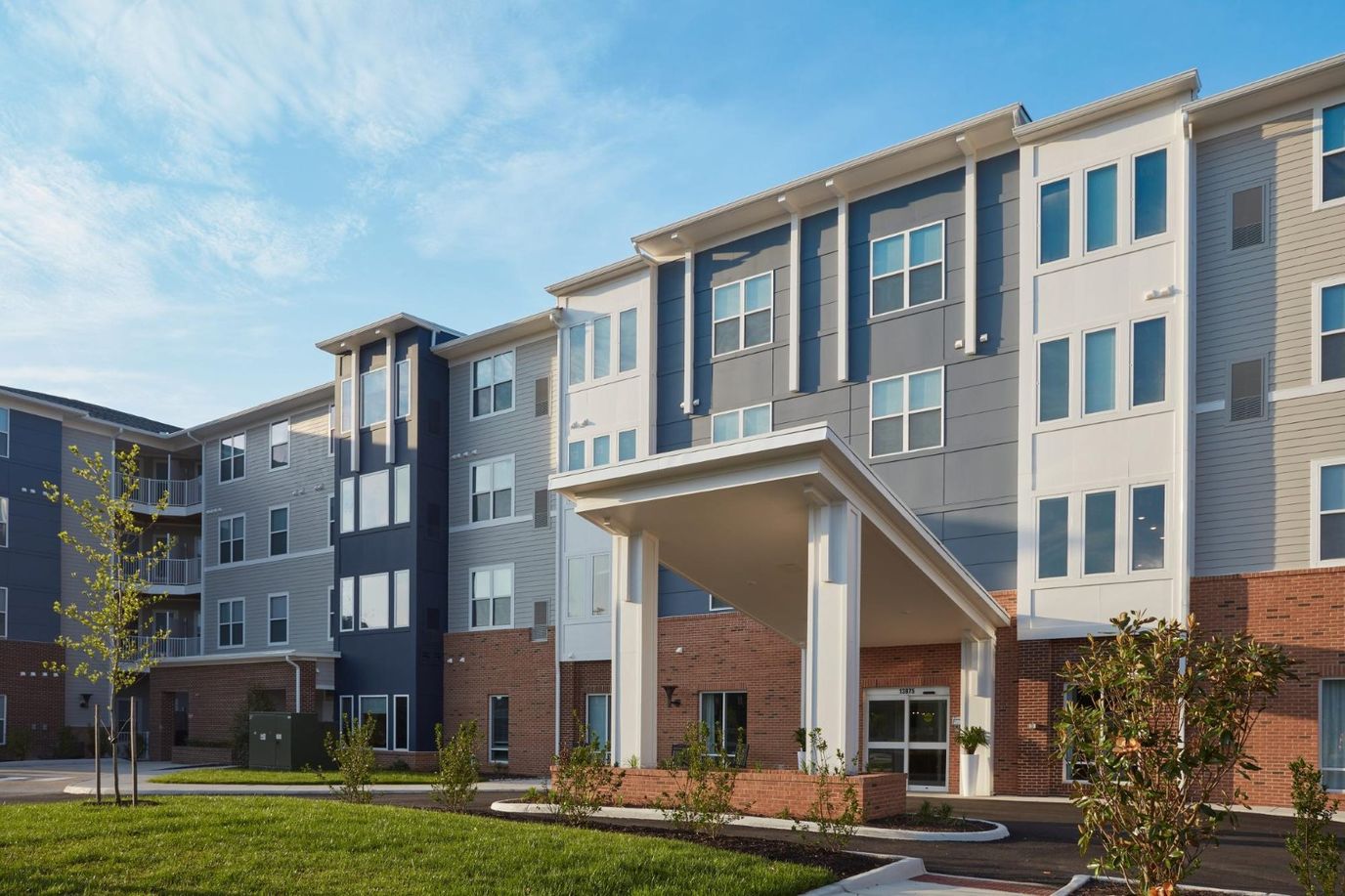 Modern assisted living facility exterior with landscaping