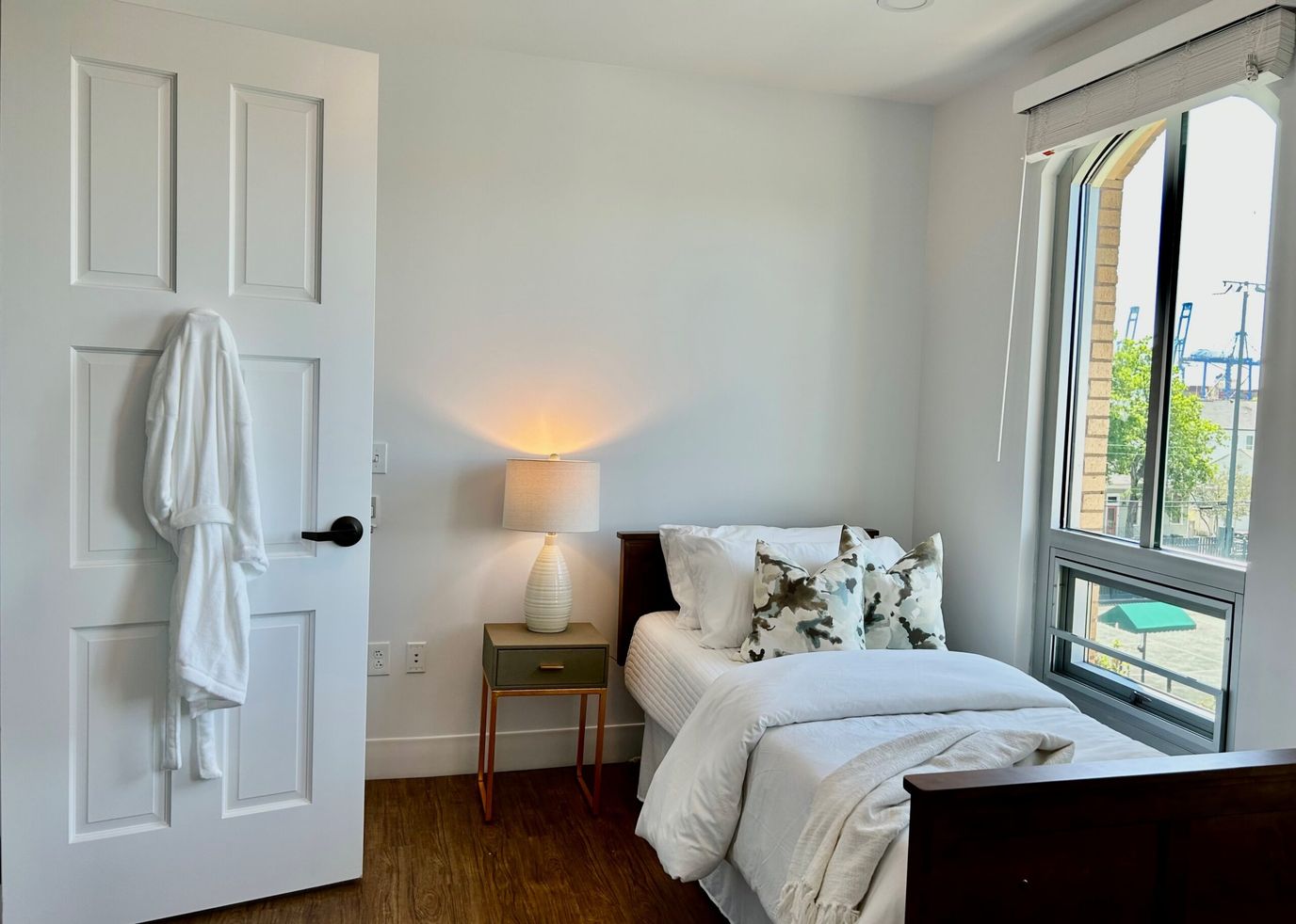 Cozy resident room with a bed and bedside lamp