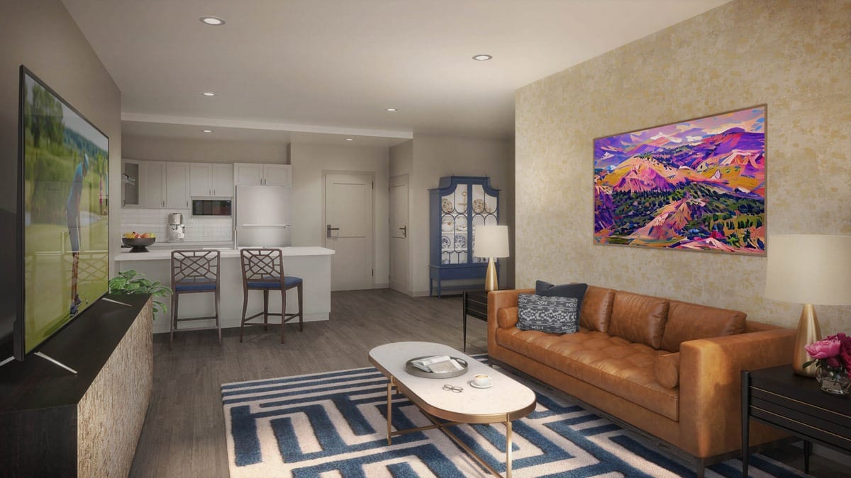 A cozy interior space with a lounge and kitchen area
