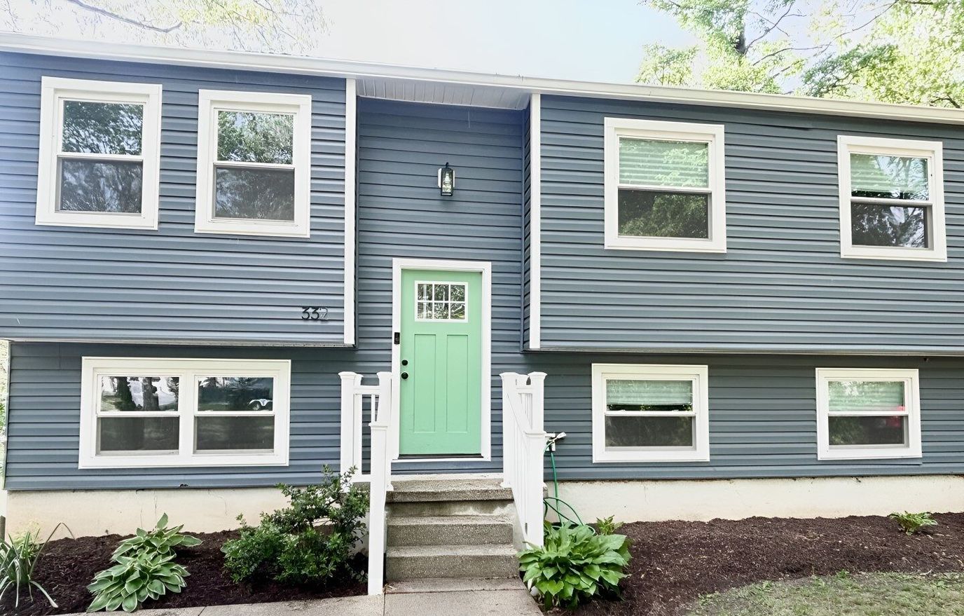 Exterior view of a residential building with a green door