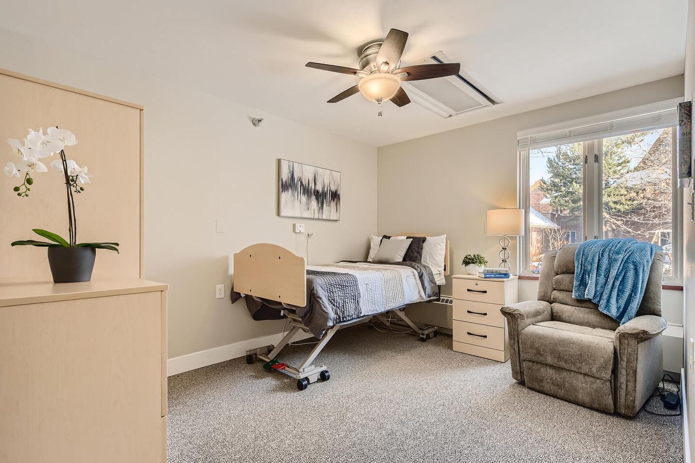Cozy private resident room with a bed and chair