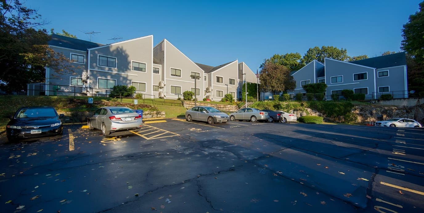 Exterior view of Hill Top Homes with parking area