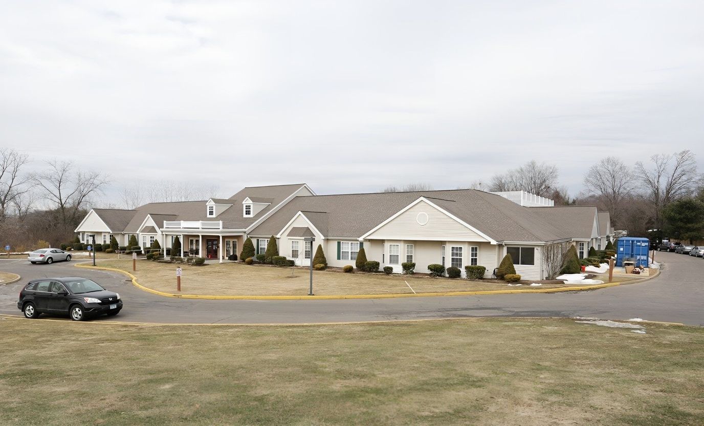 Exterior view of the assisted living facility with parking lot