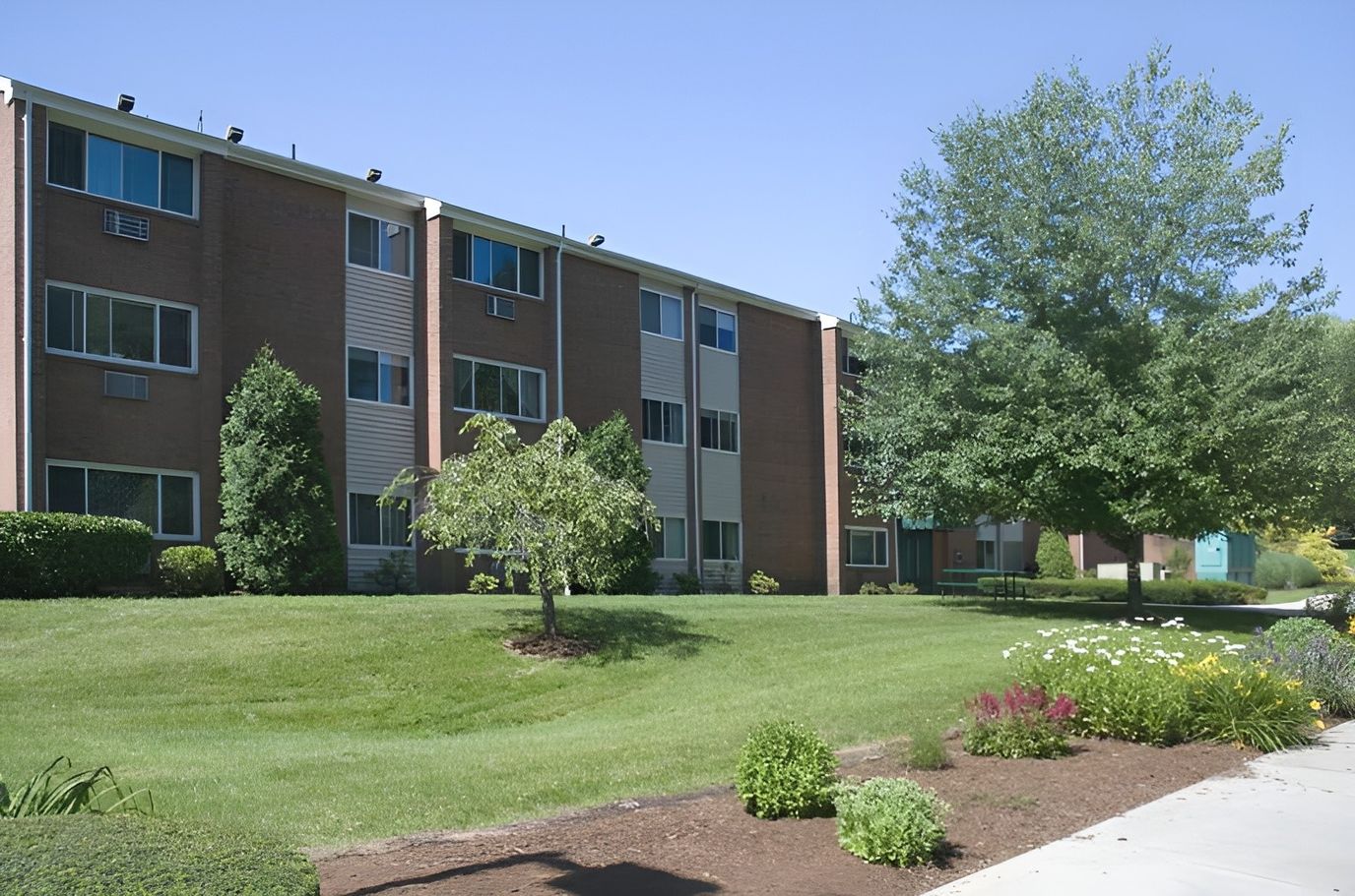 Exterior view of Federation Square Apartments with landscaped grounds